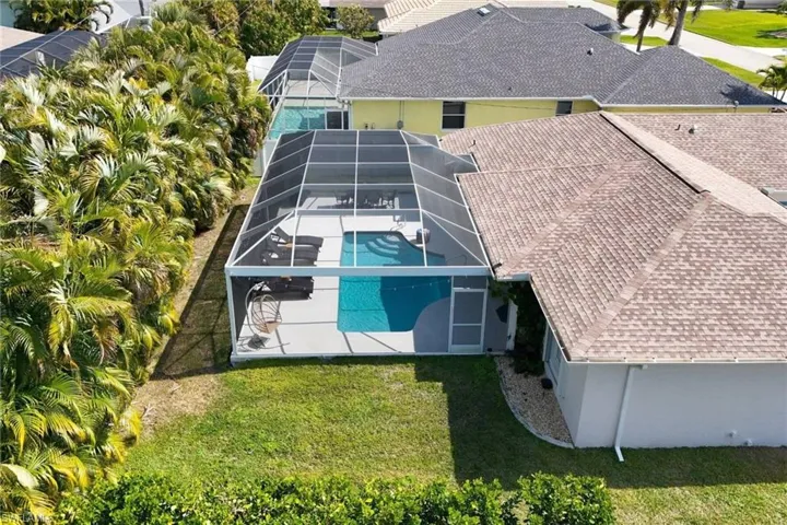 Tall, privacy palms and hedges around rear yard.