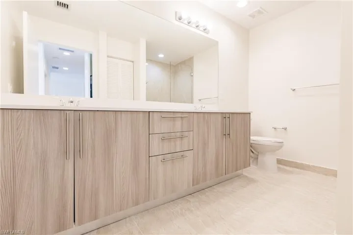 Primary bathroom with tile floors, toilet, and vanity
