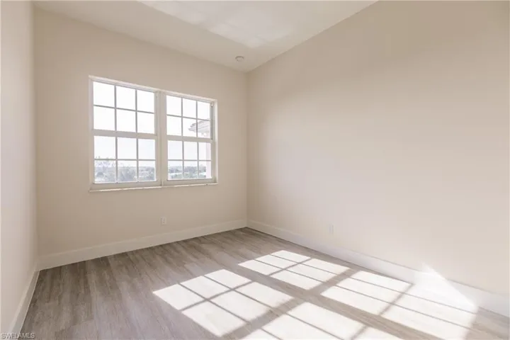 Bedroom featuring light vinyl plank flooring