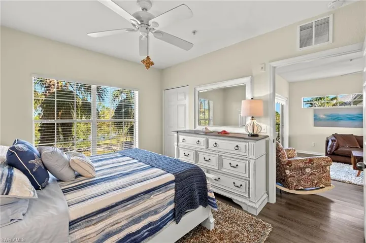 Bedroom with hardwood / wood-style floors, ceiling fan, and a closet