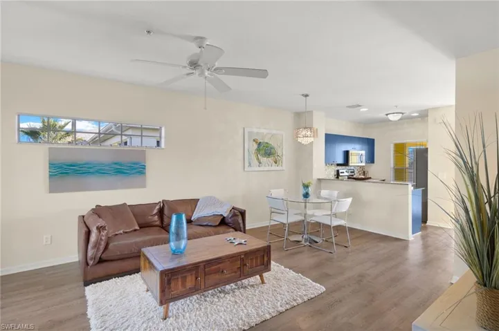 Living room featuring ceiling fan and wood-type flooring