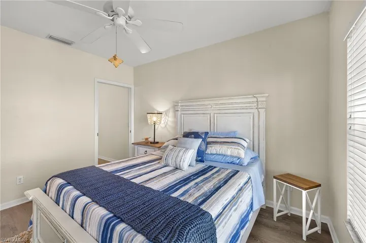 Bedroom featuring ceiling fan and dark wood-type flooring