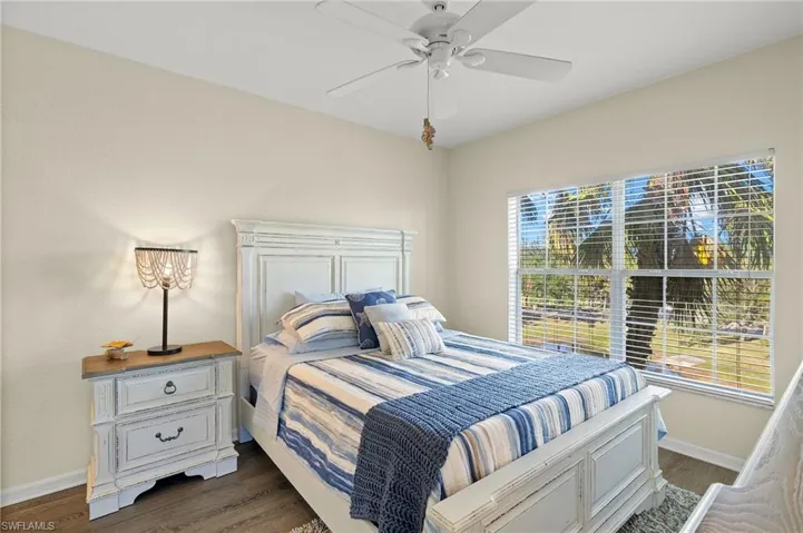 Bedroom with ceiling fan and dark hardwood / wood-style flooring