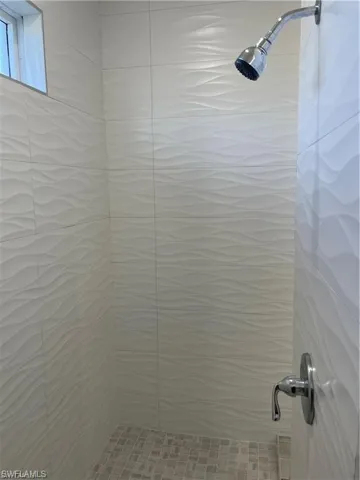 Bathroom with a shower with shower curtain