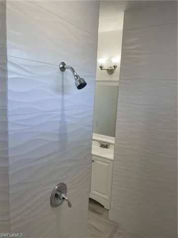 Bathroom featuring walk in shower and vanity