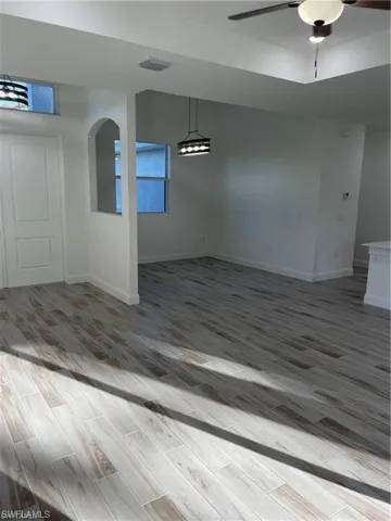 Unfurnished dining area with hardwood / wood-style flooring and ceiling fan