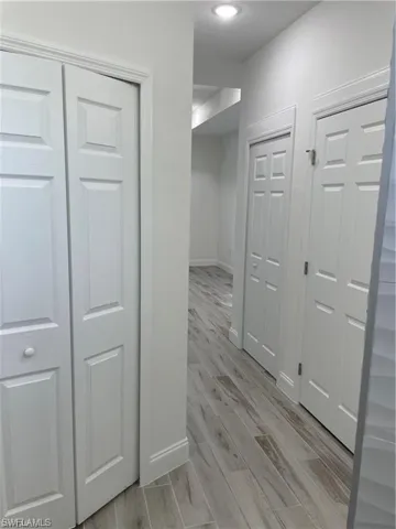 Hallway with light hardwood / wood-style flooring