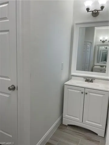 Bathroom with vanity and wood-type flooring