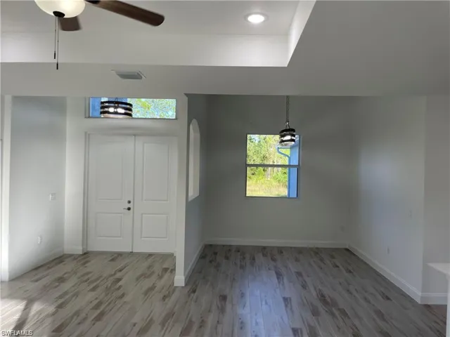 Entrance foyer with wood-type flooring and ceiling fan