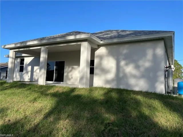 Rear view of house with a yard
