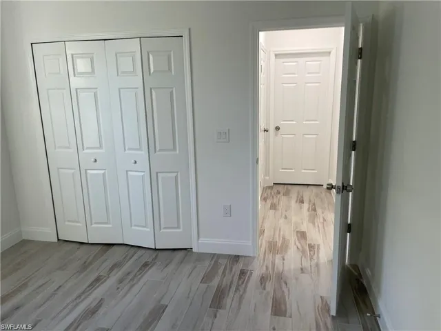 Unfurnished bedroom with a closet and light wood-type flooring