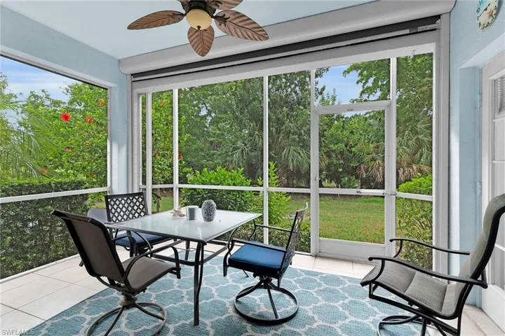 Sunroom / solarium with ceiling fan and outdoor dining area