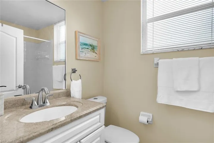 Bathroom featuring vanity and a shower