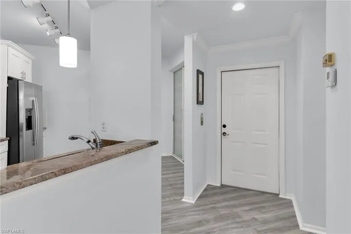 Entrance foyer featuring light wood finished floors, crown molding, and recessed lighting