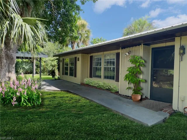 Back of property with a patio area and a yard