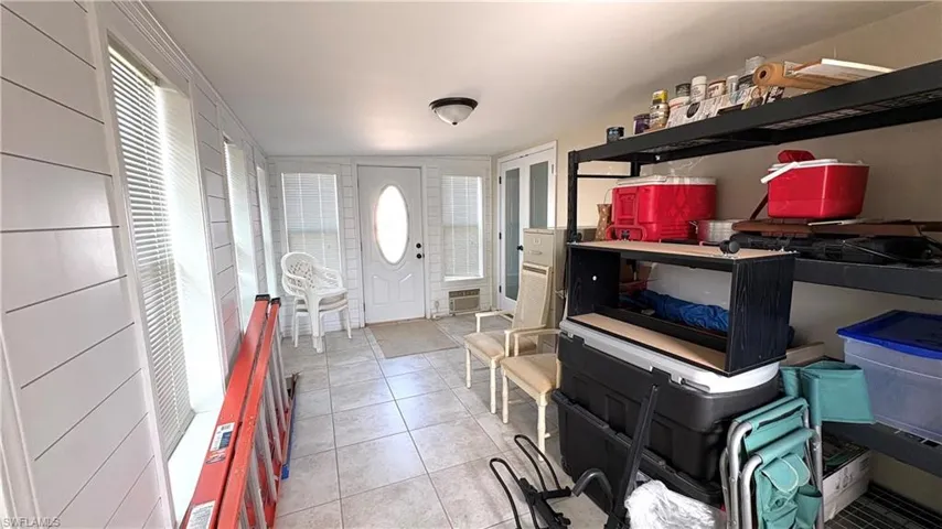 Enclosed sunroom is currently used for storage, but will make a wonderful living space as it is air-conditioned and has new windows and doors.