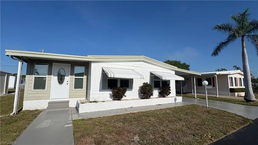 The spacious home features a covered entry, new windows and doors, and a concrete walkway