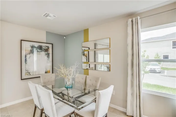 Dining space with light tile patterned floors