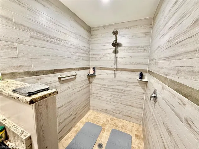 Walk in shower with multiple heads.