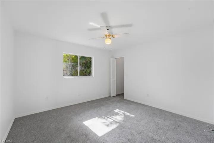 Bedroom featuring white walls and grey carpeting