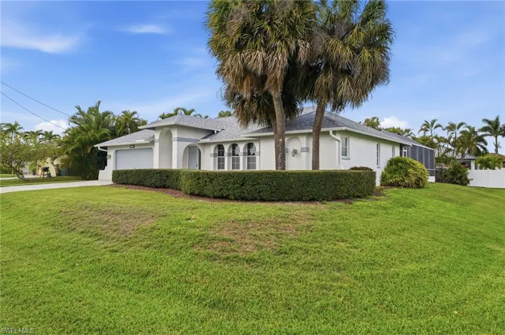 White stucco exterior with a gray tile roof