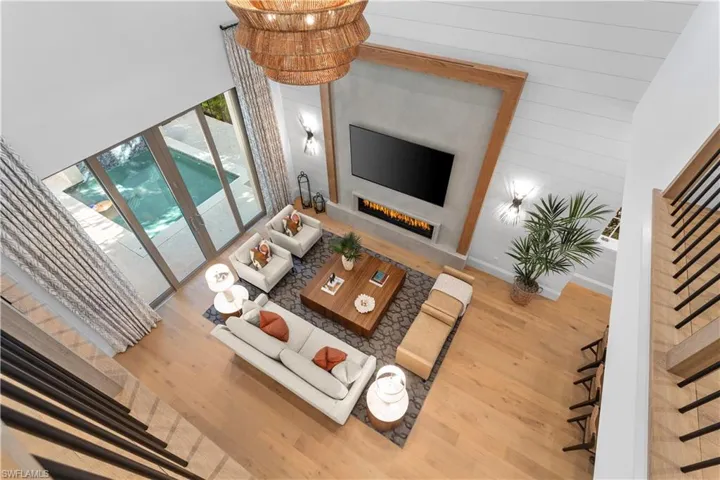 Living area with wood finished floors and a glass covered fireplace
