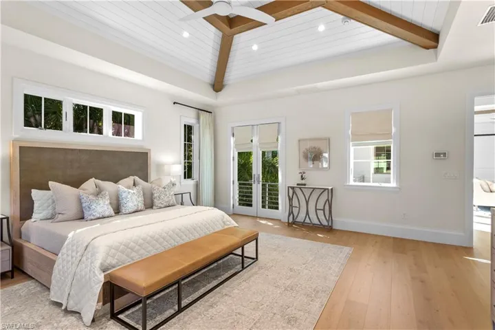 Bedroom featuring access to outside, multiple windows, light wood-style floors, baseboards, and recessed lighting