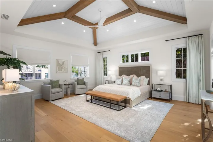 Bedroom featuring light wood-type flooring, recessed lighting, wood ceiling with exposed beams, and baseboards