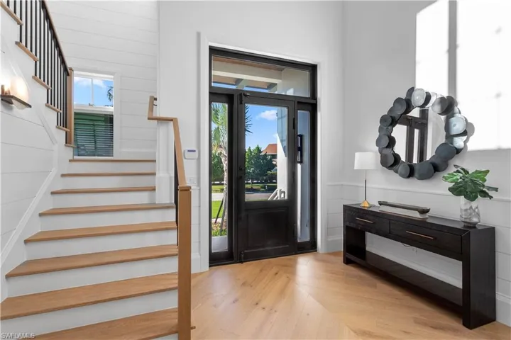 Foyer with stairway and wood finished floors