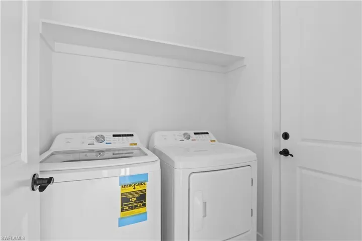 Washroom with washing machine and clothes dryer