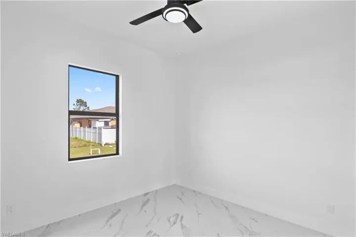 Empty room with marble finish flooring and ceiling fan