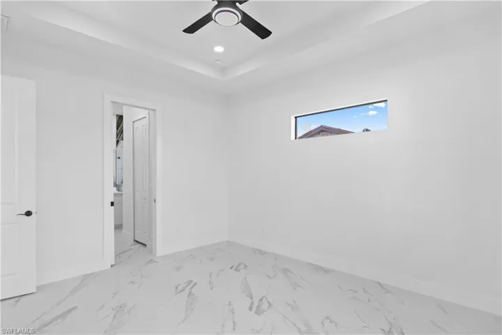 Spare room featuring light marble finish flooring, recessed lighting, and a ceiling fan