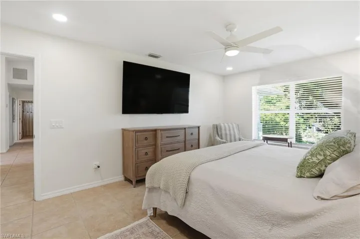 Bedroom with ceiling fan, light tile patterned floors, and recessed lighting