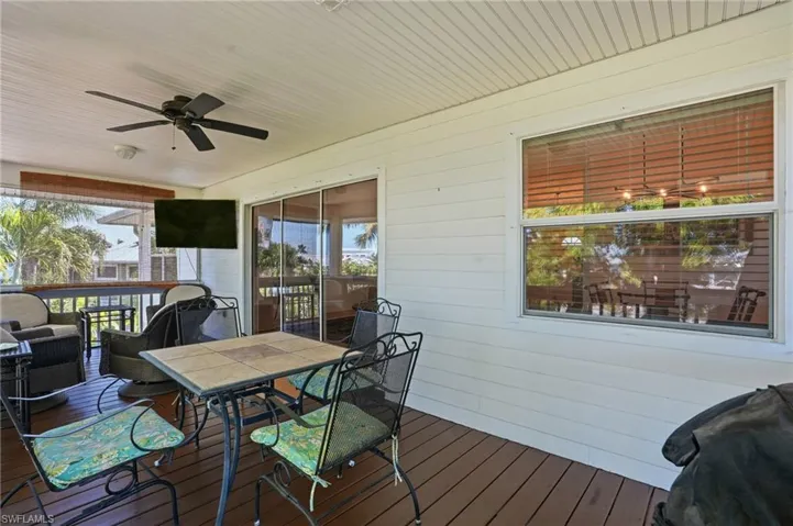Deck with a ceiling fan and outdoor dining space