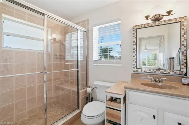 Bathroom with a shower stall and vanity