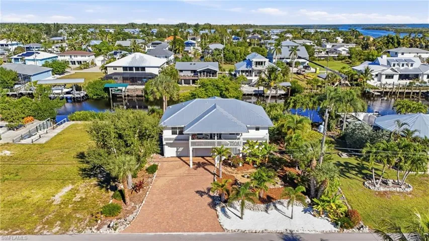 Aerial view of residential area featuring a large body of water