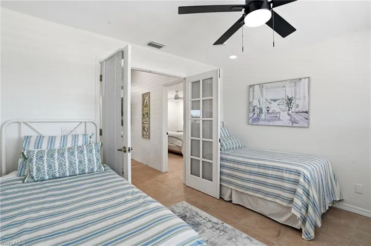 Bedroom with light tile patterned flooring, a ceiling fan, and recessed lighting