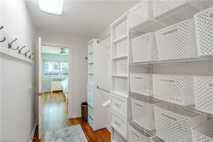 Spacious closet with wood finished floors - Virtually Edited Image