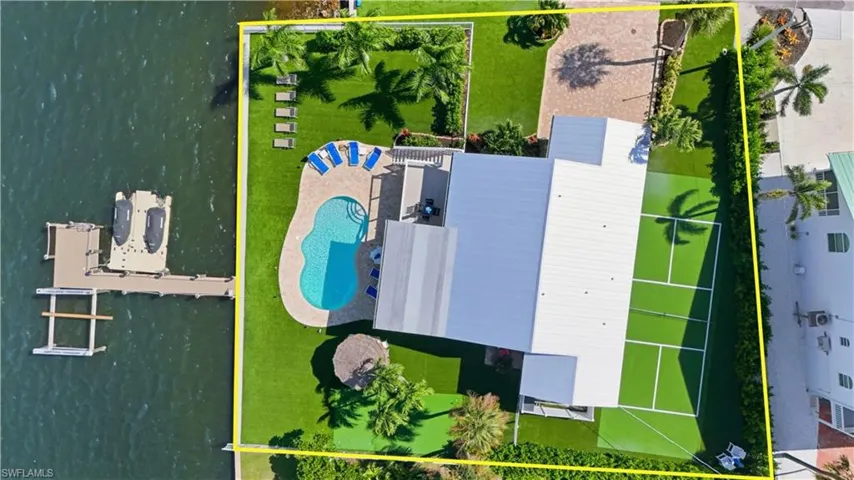 Aerial view of property and surrounding area featuring property parcel outlined - Virtually Edited Image