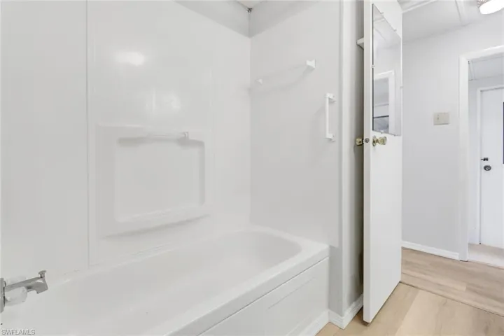 Bathroom with hardwood / wood-style flooring