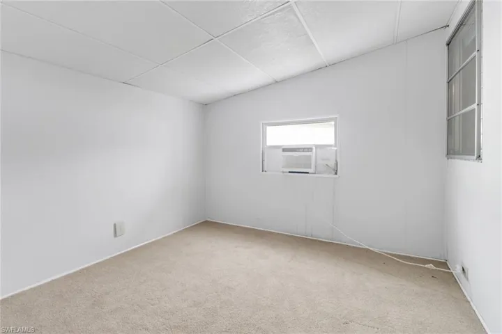 Empty room with cooling unit and carpet