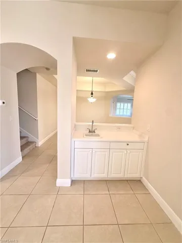 Breakfast nook with sink in kitchen with view to dining provides space for work, coffee and wine