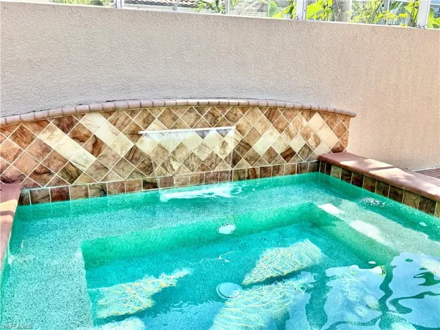 Relaxing view of water feature in oversized sit in spa with a hot tub