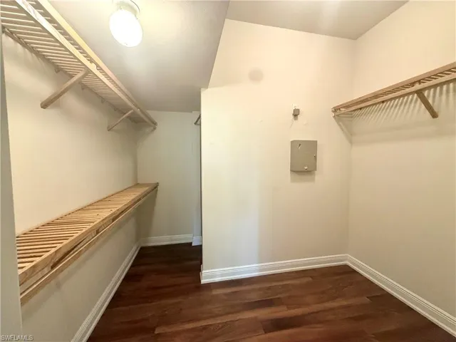 Master Suite  Walk In Closet. Master Suite on ground floor  featuring wood flooring, wood shelving and ample light