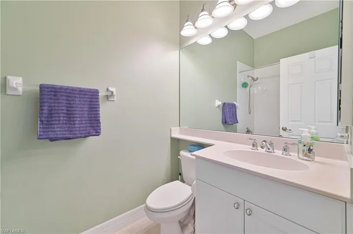 Bathroom featuring vanity and a shower