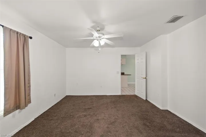 Spare room featuring ceiling fan and carpet floors