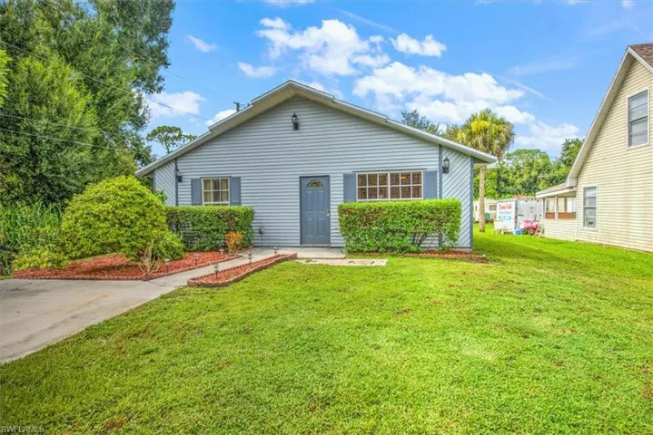 Rear view of property featuring a lawn