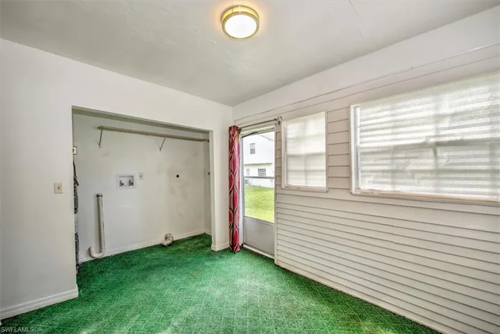 Carpeted empty room featuring baseboards