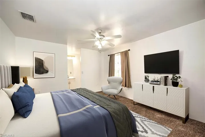 Carpeted bedroom featuring a ceiling fan and connected bathroom