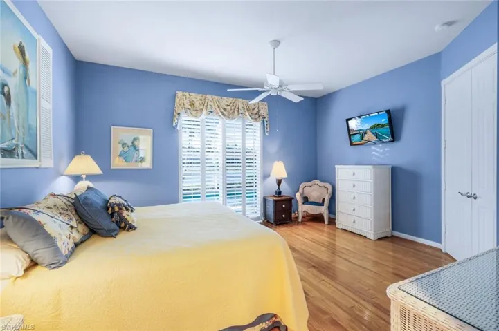 Bedroom featuring hardwood / wood-style floors, a closet, and ceiling fan